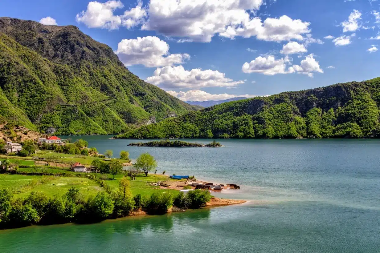 The beautiful lake Koman near the Albanian Alps. It is surrounded by dense forested hills, vertical slopes, deep gorges.